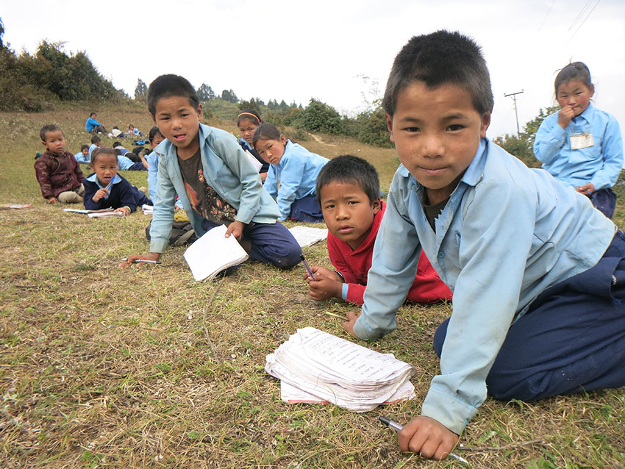 Students, studying out side the class room, made unsafe by the quakes in 2015.